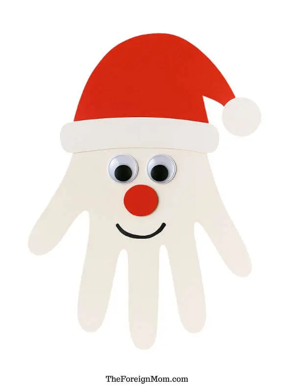 Santa Claus handprint beard craft for toddlers made with red paper hat, google eyes, and cotton balls. A fun Christmas activity for preschoolers.