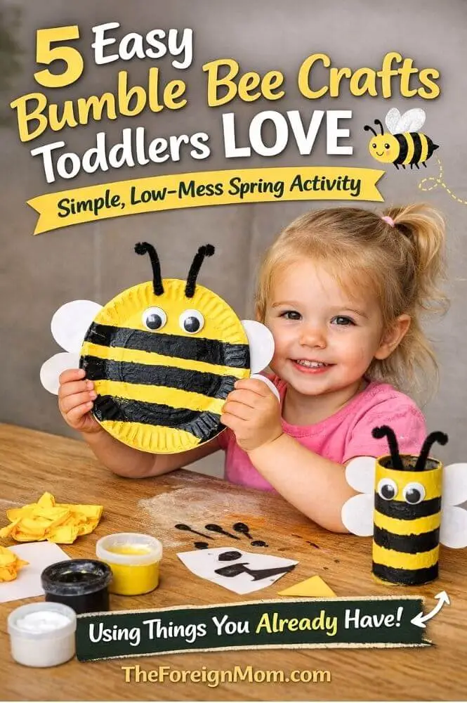 Toddler holding a paper plate bumble bee craft with yellow paint black stripes googly eyes wings and antenna easy spring craft for kids.