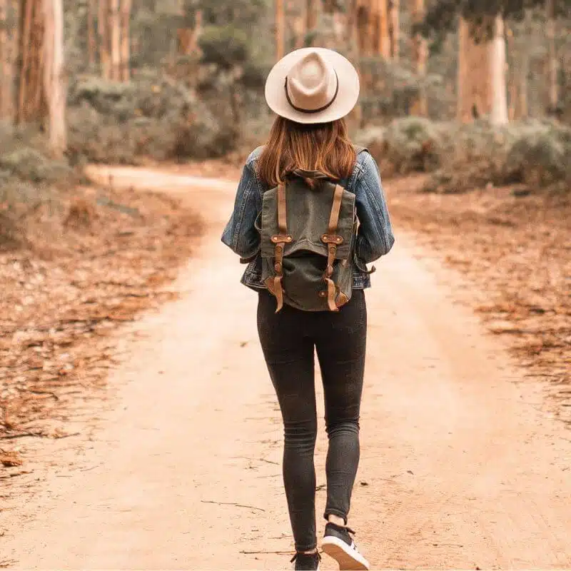 Mom walking alone on a nature path enjoying peaceful personal time.