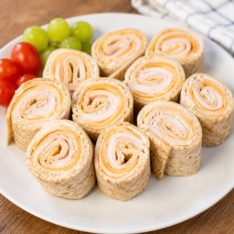 Turkey and cheddar cheese pinwheels made with a whole wheat tortilla.
