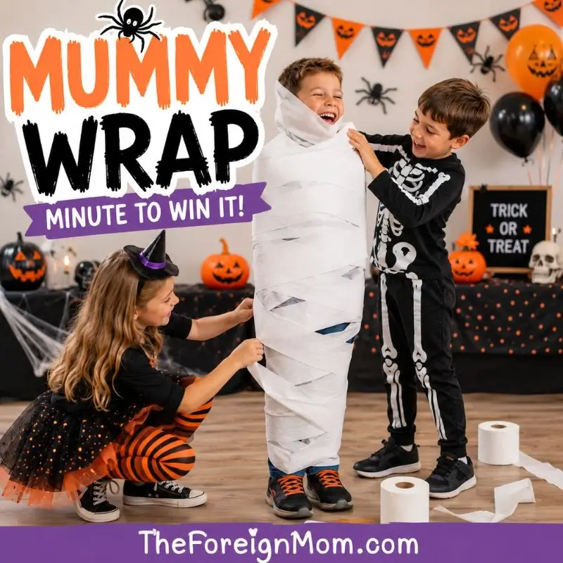 Kids playing the Mummy Wrap Halloween minute to win it game with toilet paper at a Halloween party.