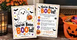 Two You’ve Been Booed printable pages beside a Halloween candy bucket on a front porch.