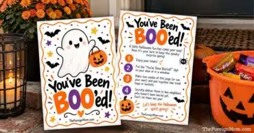 Two You’ve Been Booed printable pages beside a Halloween candy bucket on a front porch.