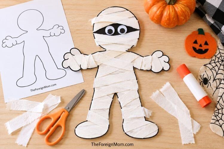 Free mummy template printable made into an easy Halloween mummy craft for kids.