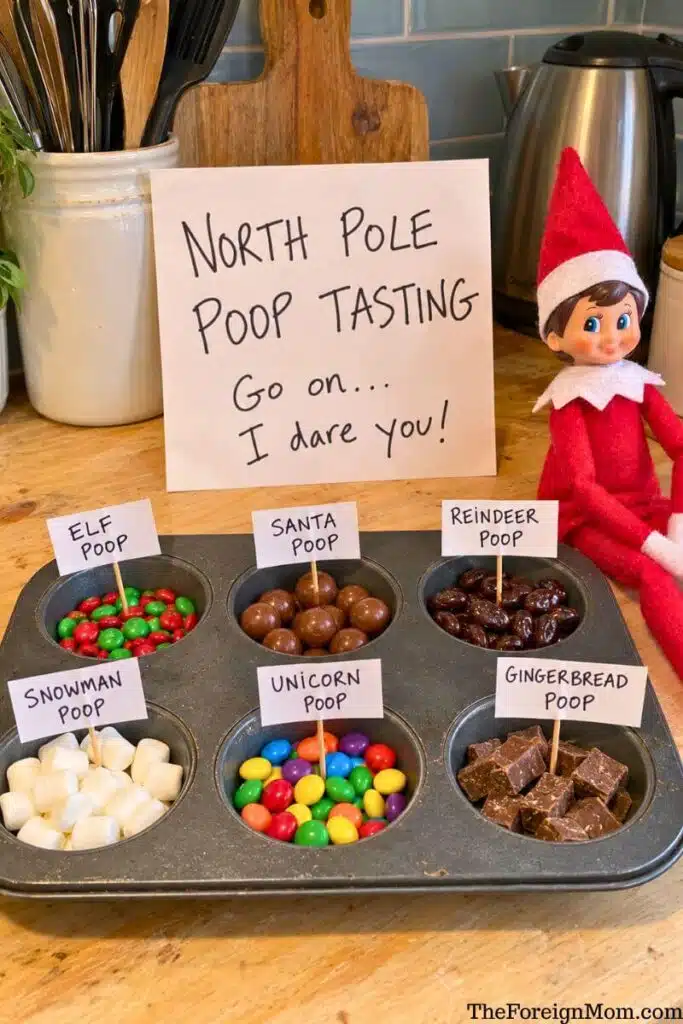 Funny Elf on the Shelf idea featuring a North Pole poop tasting station with six types of candy labeled elf, Santa, reindeer, snowman, unicorn, and gingerbread poop.