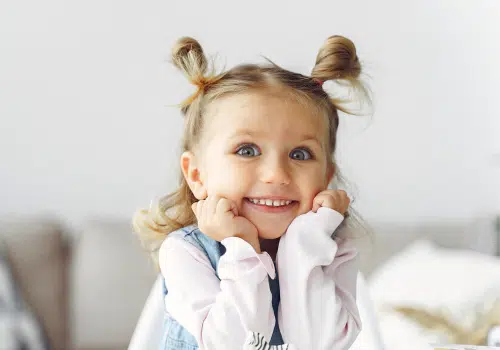 Toddler girl with bunny ear hairstyle.