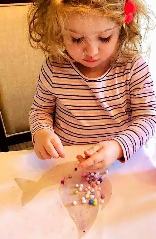 Toddler decorating peace dove craft.